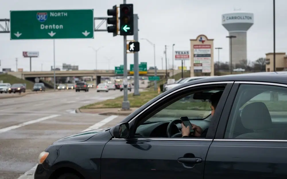 Driver looking at phone at an intersection near I-35E