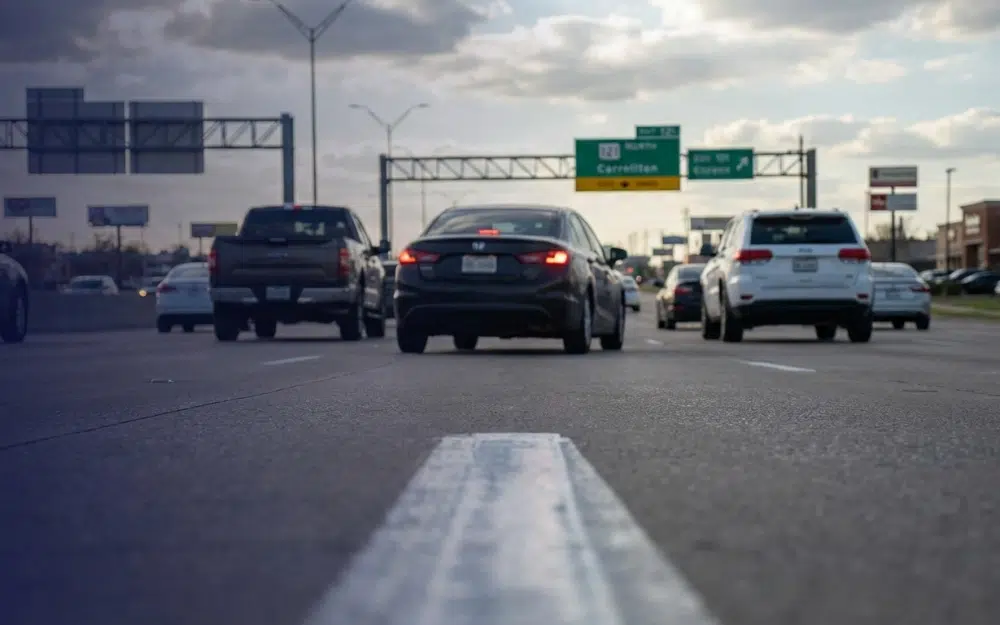 Vehicle weaving through traffic on SH-121